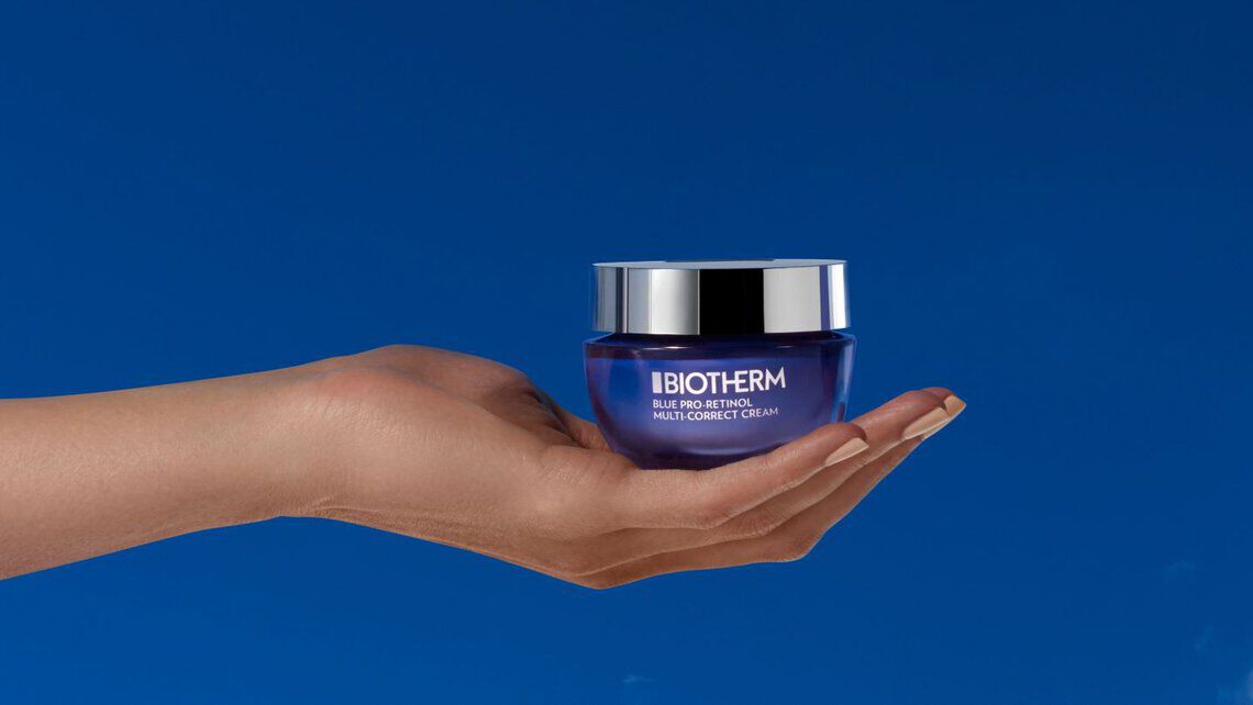 pro-retinol multi-correct crean in hand on a bleu background