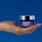 pro-retinol multi-correct crean in hand on a bleu background