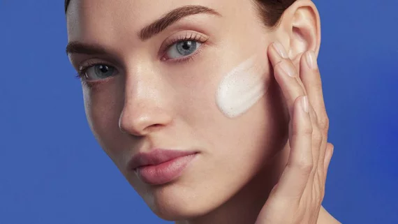 woman applying cleanser on her face