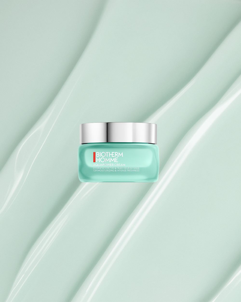 Turkise Creme-Dose mit silbernem Deckel, Text: "BIOTHERM HOMME AQUAPOWER CREAM".