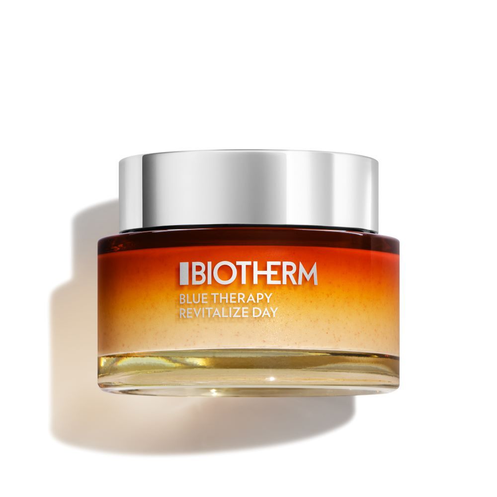 Ein Cremetiegel steht aufrecht vor weißem Hintergrund, der Deckel ist silbern, die Aufschrift orange.